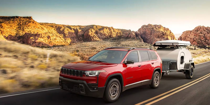 2026 Jeep Cherokee near dusty mountains