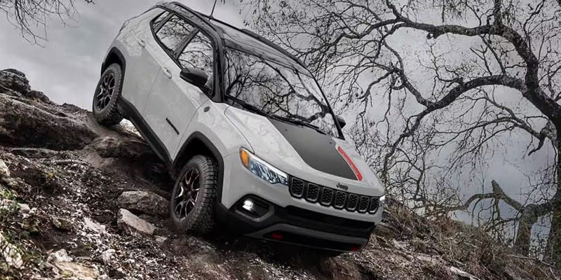 2026 Jeep Compass driving through mountain wooded area