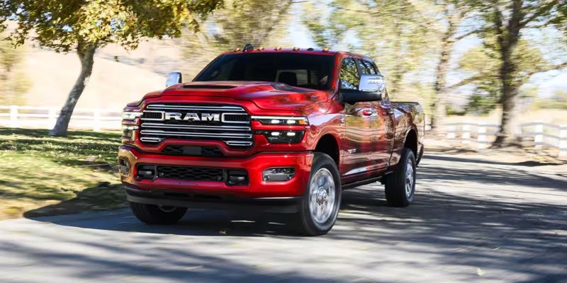 Red 2026 RAM 2500 driving under trees near Dansville, NY